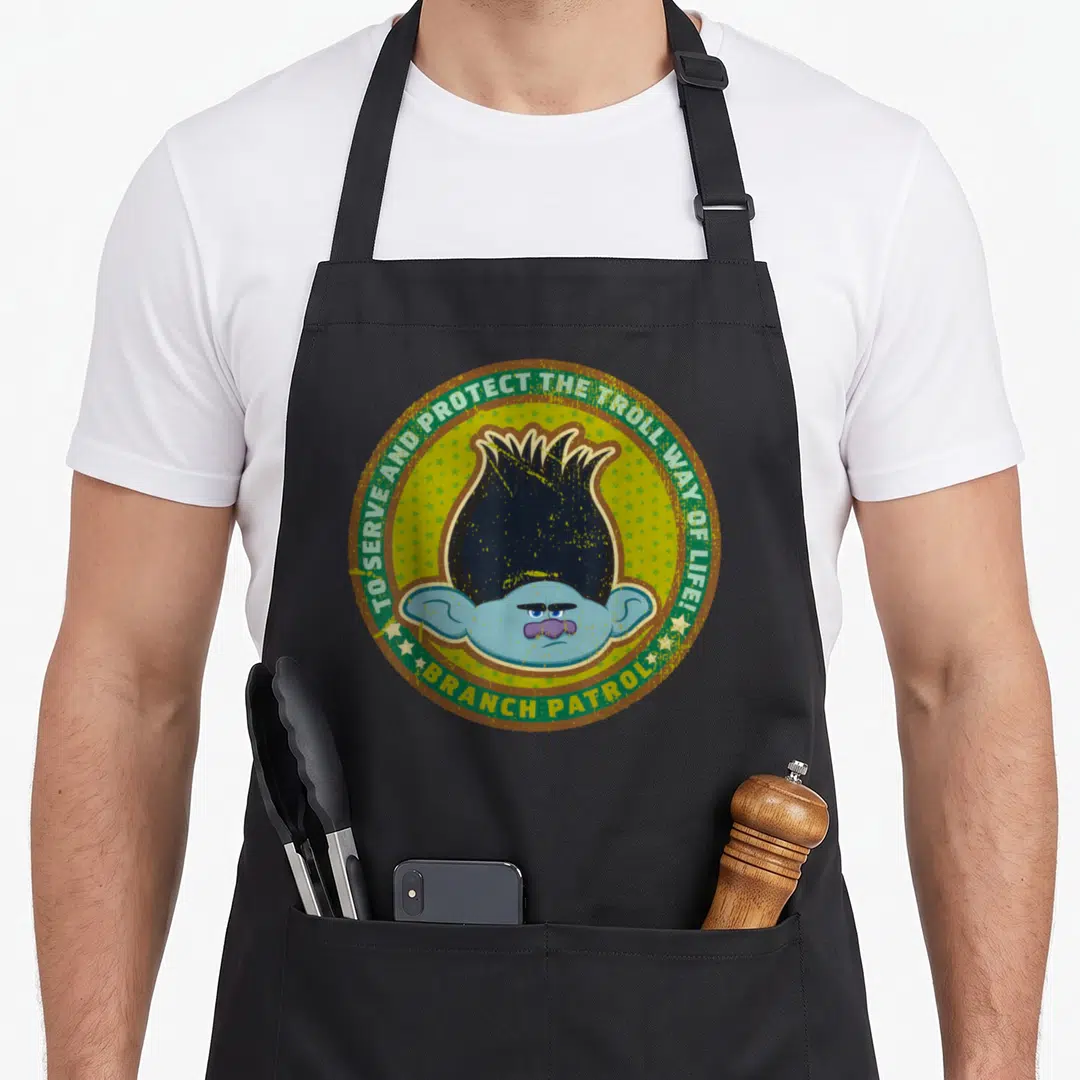 Patrol troll apron - Circular emblem with blue troll head, green stars, and patrol text on yellow background — shown on a black cotton canvas apron against a white background