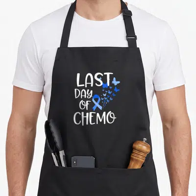 Chemo colon ribbon apron - White LAST DAY OF CHEMO text with blue ribbon and butterflies — shown on a black cotton canvas apron against a white background