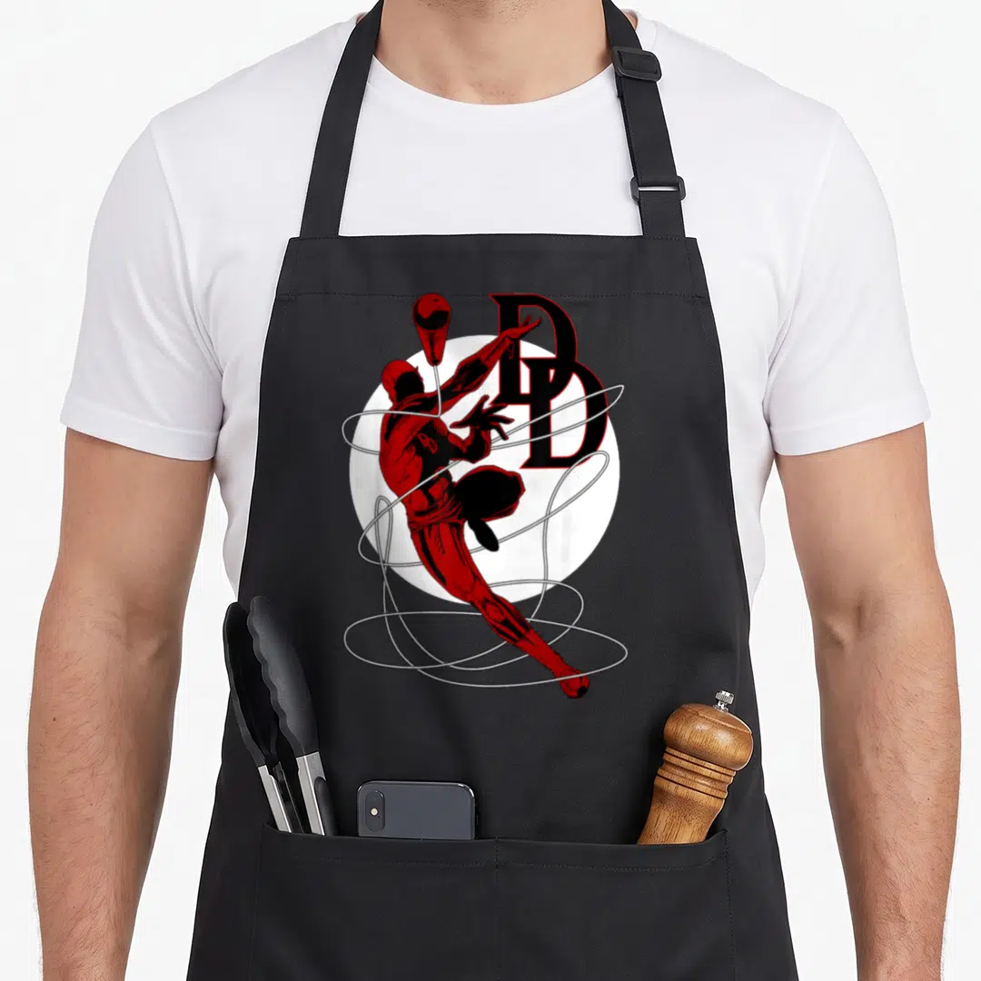 Daredevil jump rope apron - Red and black superhero leaping through white webbing near large DD letters — shown on a black cotton canvas apron against a white background