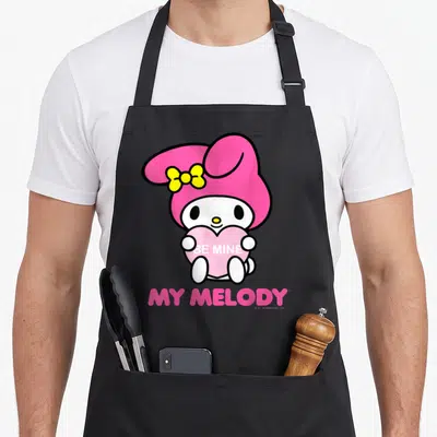 Melody valentine apron - My Melody holding pink heart with Be Mine text and logo below — shown on a black cotton canvas apron against a white background