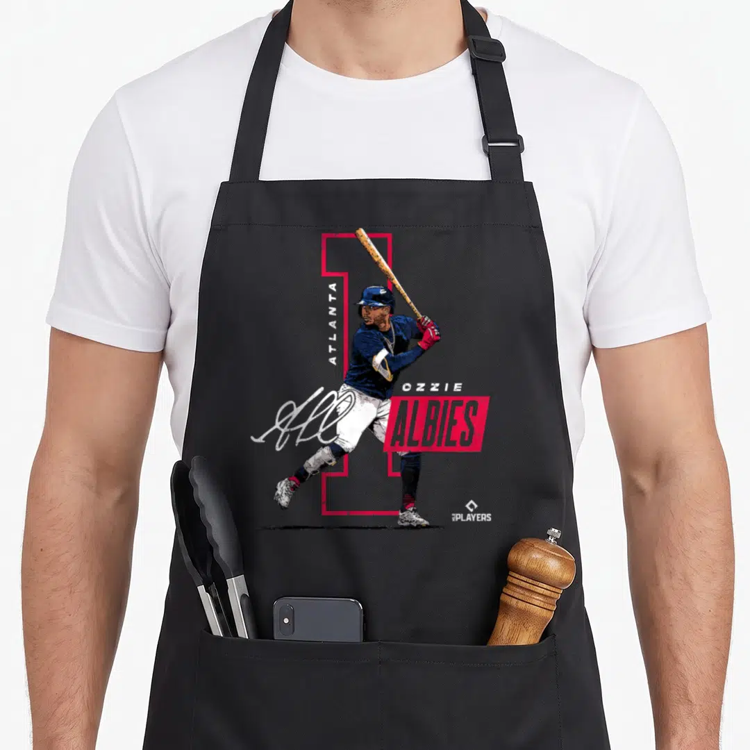 Ozzie baseball apron - Baseball player batting stance with ATLANTA OZZIE ALBIES text and red navy graphics — shown on a black cotton canvas apron against a white background
