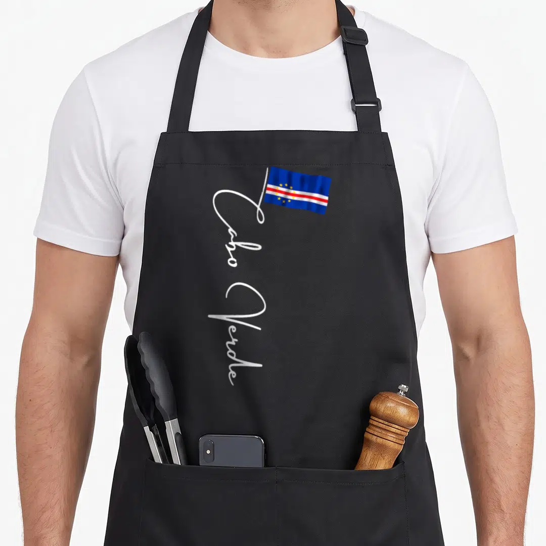 Cabo pride apron - Waving flag in blue white red with vertical Cabo Verde script text — shown on a black cotton canvas apron against a white background