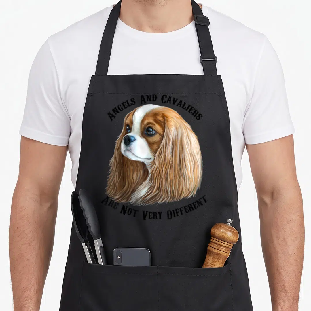 Blenheim king apron - Realistic brown and white spaniel head with arched text reading Angels and Cavaliers Are Not Very — shown on a black cotton canvas apron against a white background