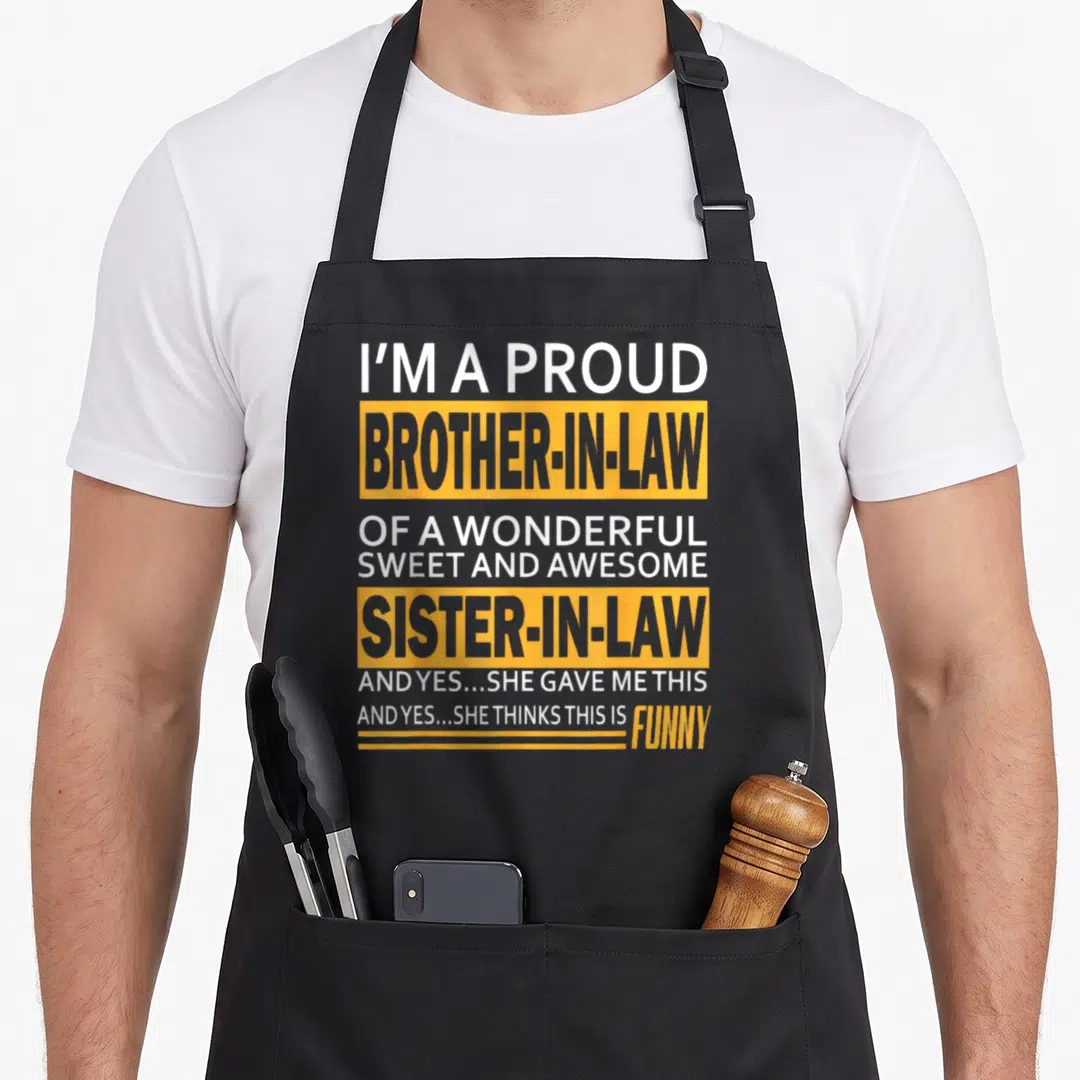 Brother father day apron - Stacked white and grey text inside yellow blocks reading I'm a proud brother-in-law — shown on a black cotton canvas apron against a white background