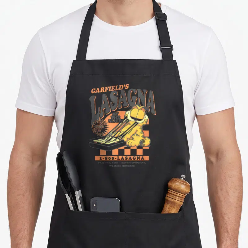 Slice lasagna apron - Garfield pulling cheese from a pan with arching text and phone number on grey background — shown on a black cotton canvas apron against a white background