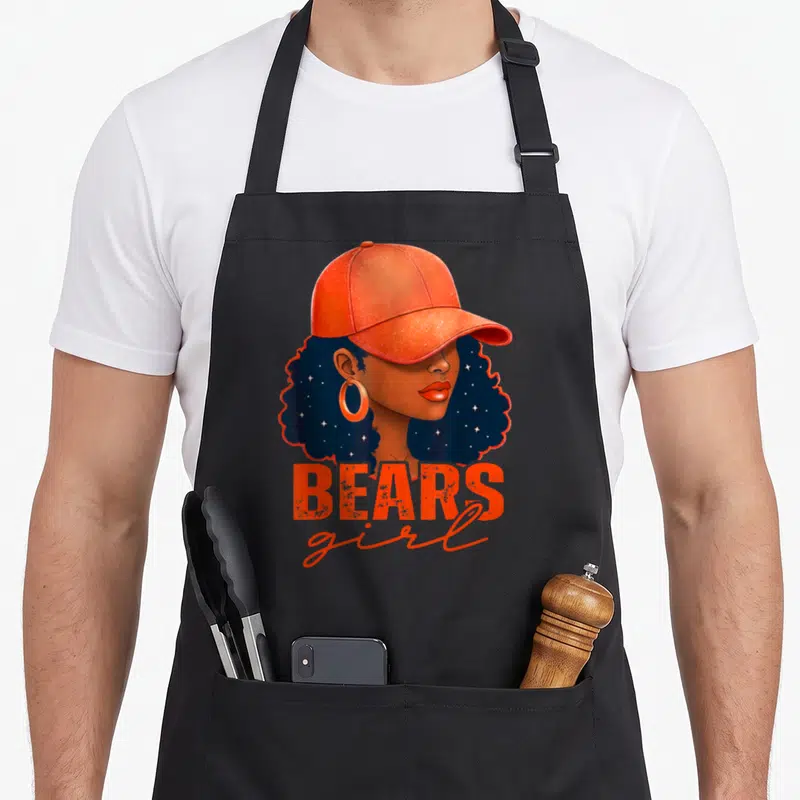 Funny sport bear apron - Cartoon woman in orange cap with BEARS girl text in navy and brown — shown on a black cotton canvas apron against a white background