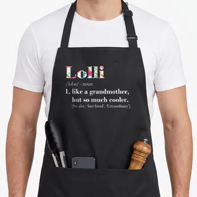 But grandmother apron - Lolli dictionary definition text with floral filled letters and cool grandmother quote — shown on a black cotton canvas apron against a white background