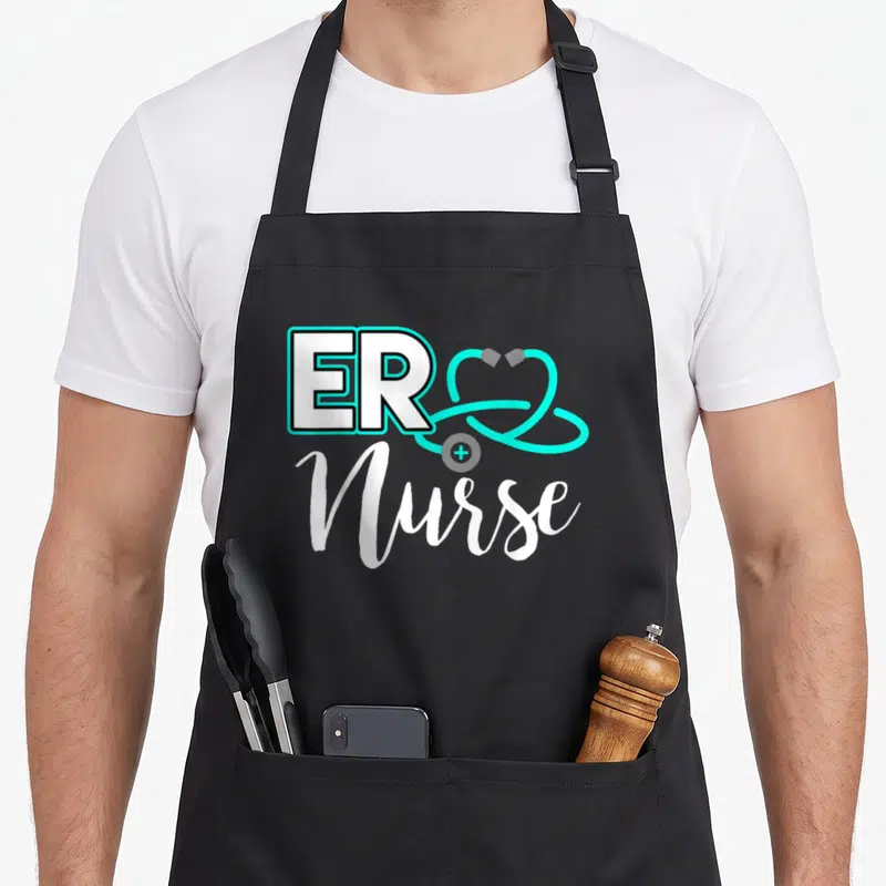 Birthday nurse apron - ER Nurse text with cyan stethoscope heart and white script lettering — shown on a black cotton canvas apron against a white background