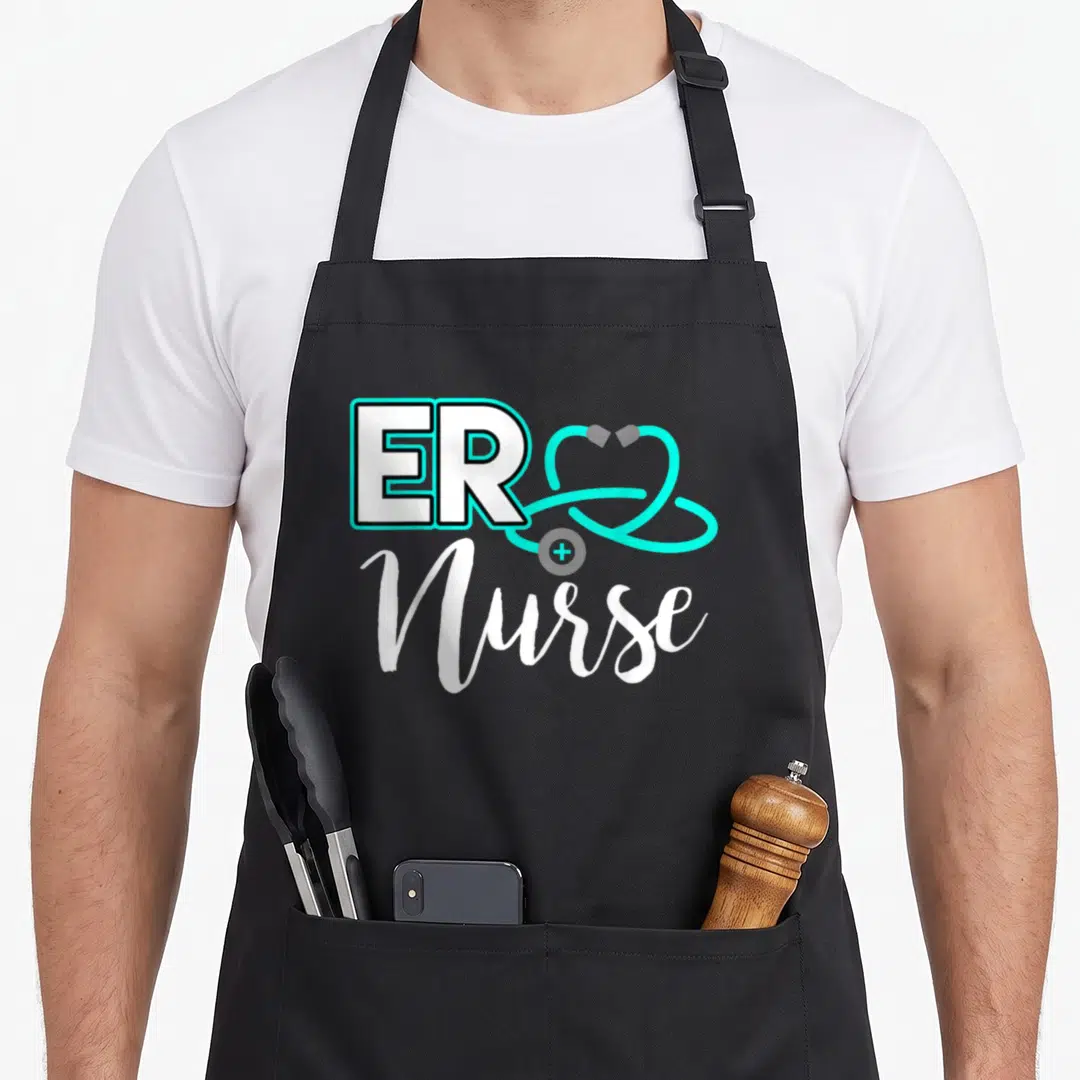 Birthday nurse apron - ER Nurse text with cyan stethoscope heart and white script lettering — shown on a black cotton canvas apron against a white background