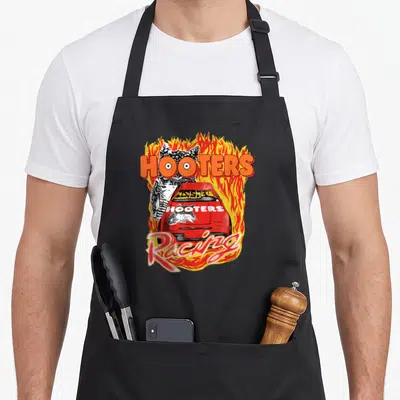 Flame racing apron - Red race car and owl surrounded by orange and yellow flames with HOOTERS and Racing text — shown on a black cotton canvas apron against a white background