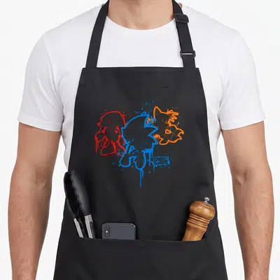 Spray paint apron - Sonic The Hedgehog line art in blue, red, orange with paint splatter effects and text at bottom — shown on a black cotton canvas apron against a white background