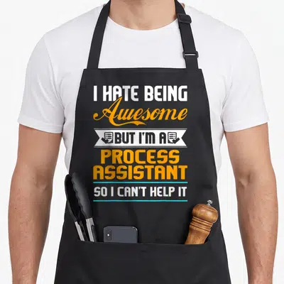 Process assistant humor apron - Stacked text I HATE BEING Awesome BUT I'M A PROCESS ASSISTANT SO I CAN'T HELP IT — shown on a black cotton canvas apron against a white background