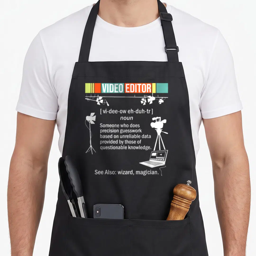 Video videography apron - Dictionary definition of Video Editor with studio lights camera and laptop in white on grey — shown on a black cotton canvas apron against a white background