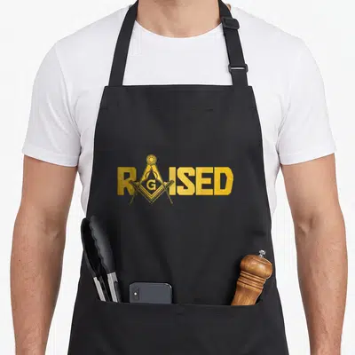 Carpenter mason apron - Gold RAISED text with Masonic square and compasses replacing the A in distressed style — shown on a black cotton canvas apron against a white background