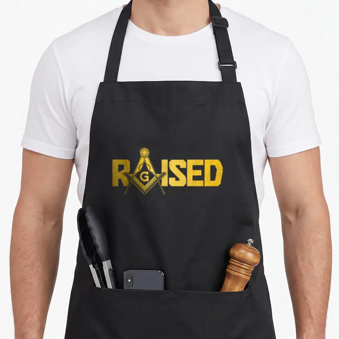 Carpenter mason apron - Gold RAISED text with Masonic square and compasses replacing the A in distressed style — shown on a black cotton canvas apron against a white background