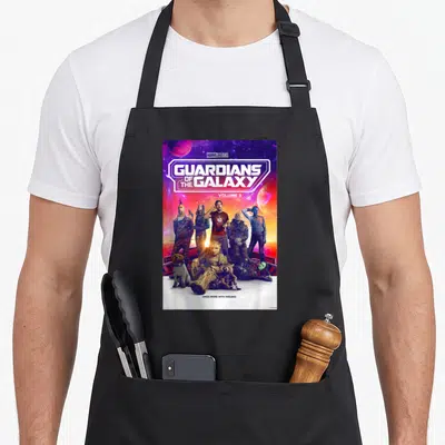 Movie galaxies apron - Guardians of the Galaxy Volume 3 poster with cast and space planets — shown on a black cotton canvas apron against a white background