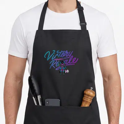 Royale ravens apron - Cartoon character standing holding umbrella and medical kit before Victory Royale text — shown on a black cotton canvas apron against a white background