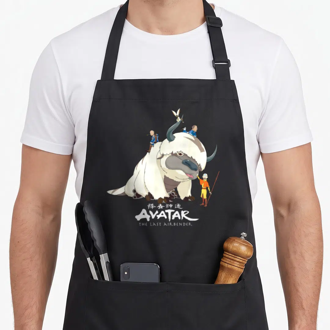 Appa anime birthday apron - Appa with Aang, Sokka, Momo and AVATAR logo in white grey yellow blue — shown on a black cotton canvas apron against a white background
