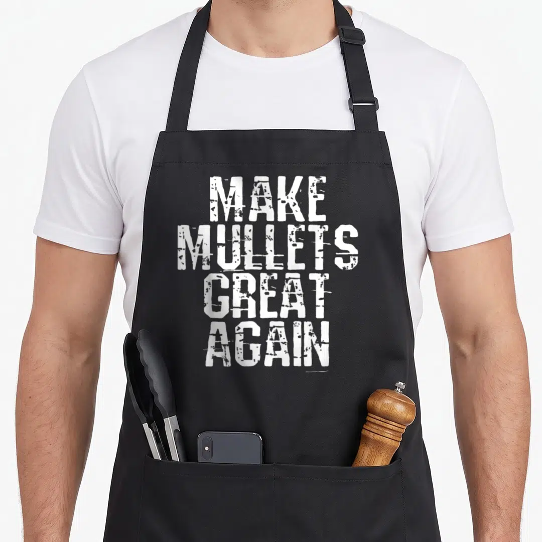 Mullet class funny apron - White stacked text reading MAKE MULLETS GREAT AGAIN in distressed typography — shown on a black cotton canvas apron against a white background