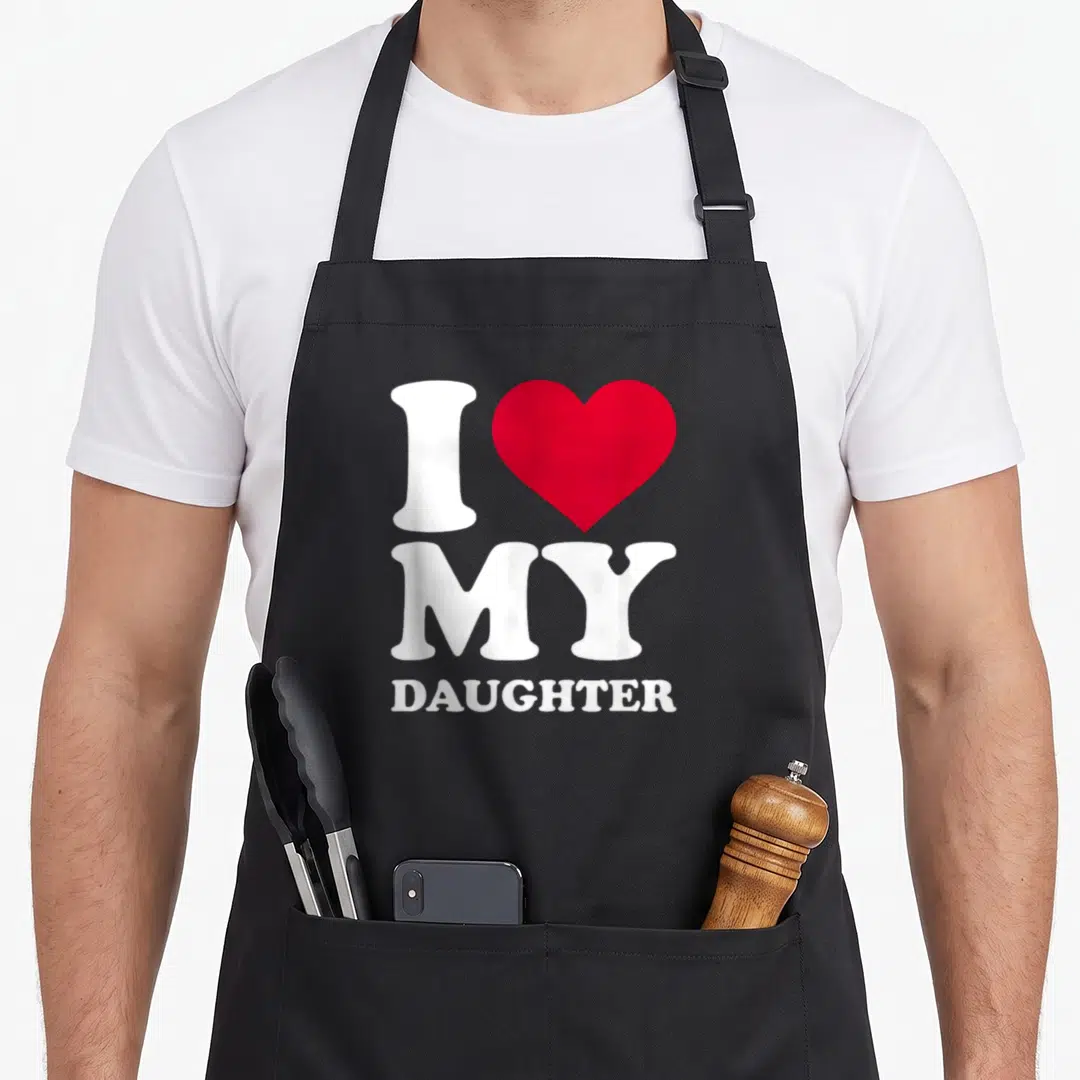 Cute mom daughter aprons - White I and MY DAUGHTER text with a red heart symbol on a black background — shown on a black cotton canvas apron against a white background