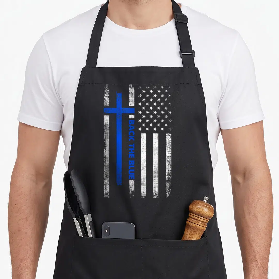 Blue cross back apron - Distressed blue cross over white stripes with vertical BACK THE BLUE text and field of white — shown on a black cotton canvas apron against a white background