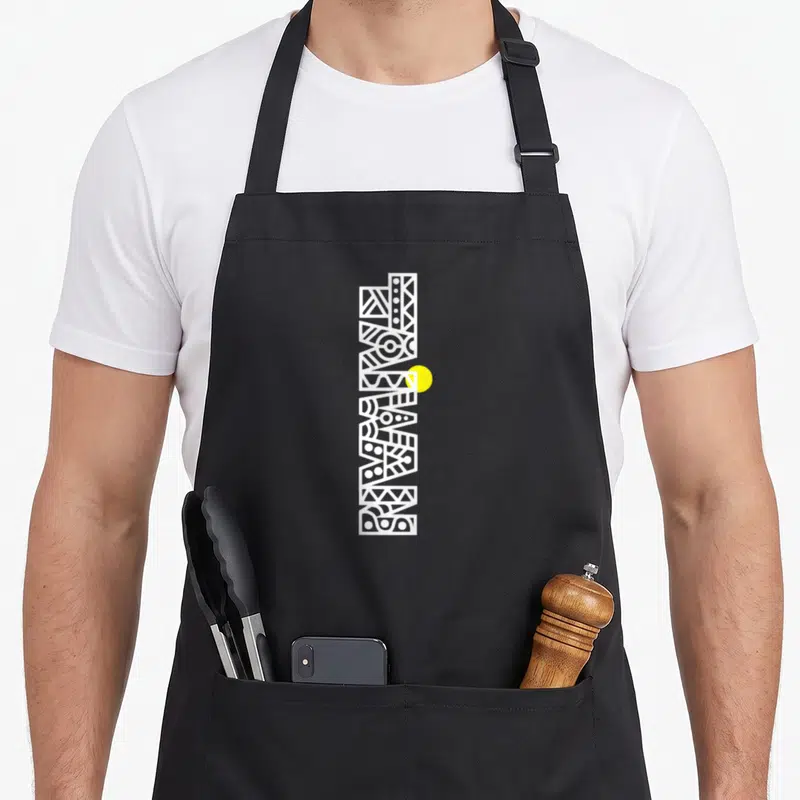 Taiwan aboriginal apron - Vertical white abstract totem with geometric patterns and overlapping yellow circle — shown on a black cotton canvas apron against a white background