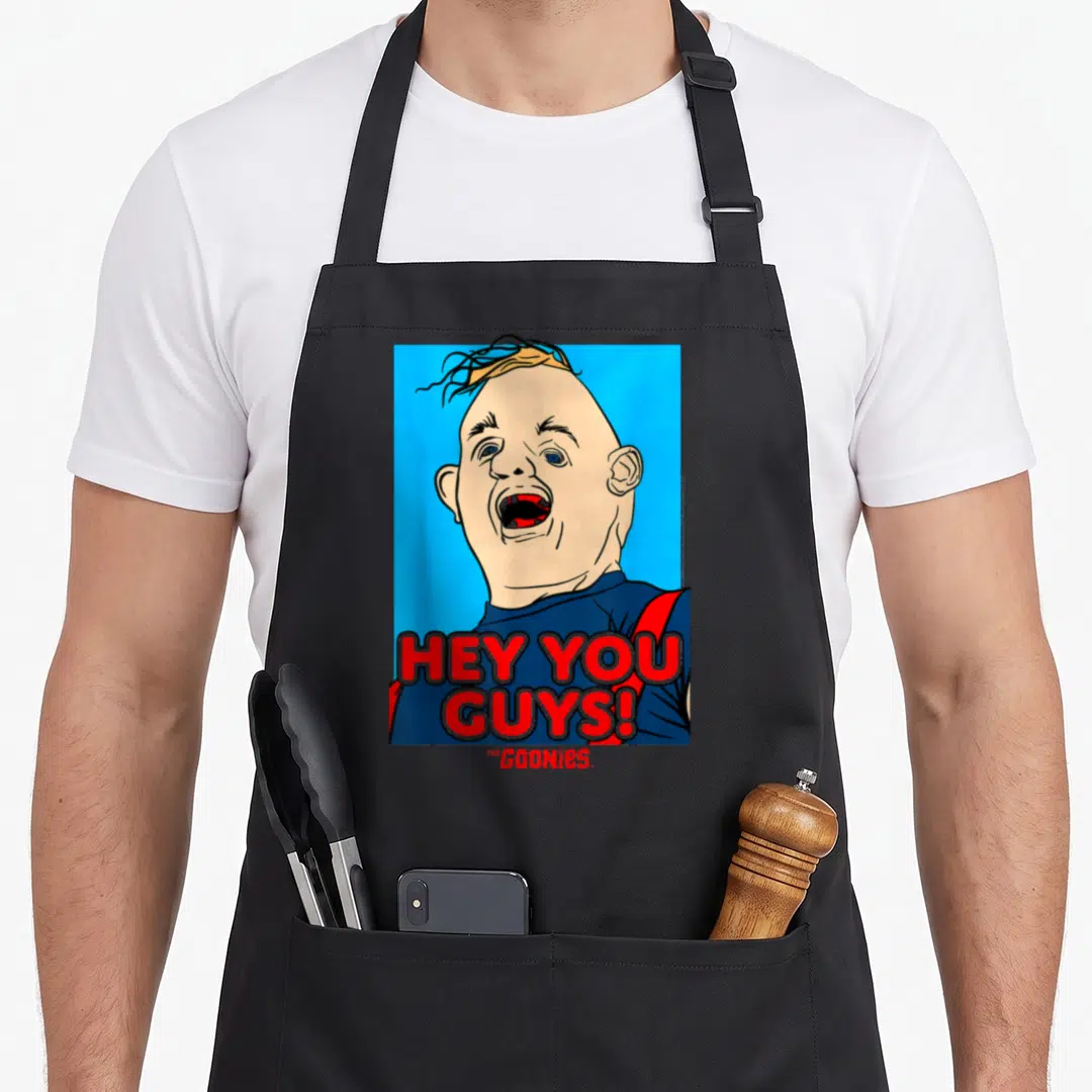 Funny hey sloth apron - Cartoon man face with open mouth and red HEY YOU GUYS text on blue background — shown on a black cotton canvas apron against a white background