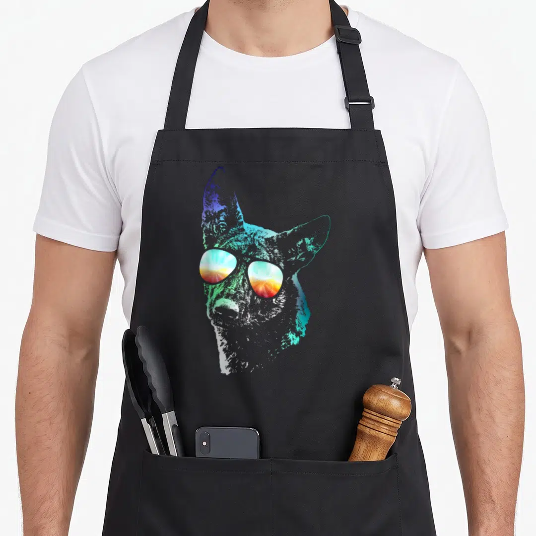 Disco dutch apron - Stylized dog head with sunglasses reflecting a sunset in blue, cyan, orange, and white gradients — shown on a black cotton canvas apron against a white background