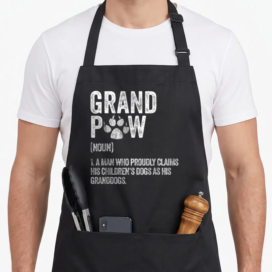 Grandpaw dog themed aprons - White dictionary definition of grandpaw with paw print replacing the letter O — shown on a black cotton canvas apron against a white background