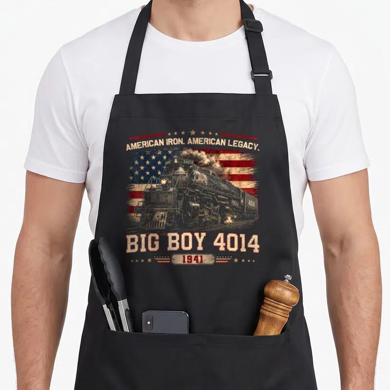 Locomotive railfan apron - Grey steam locomotive Big Boy 4014 over distressed US flag with American Iron Legacy text — shown on a black cotton canvas apron against a white background