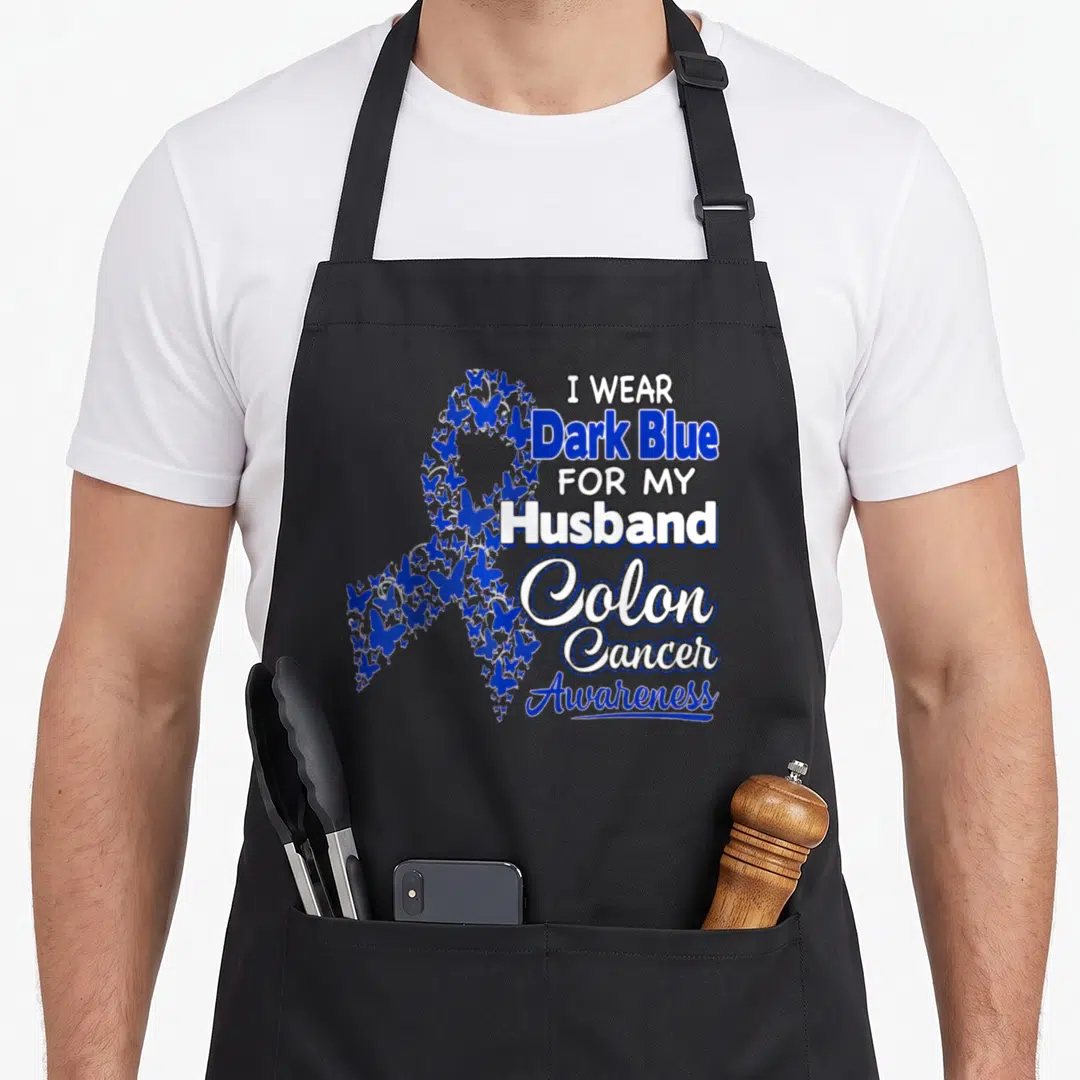 Dark husband apron - Blue butterfly awareness ribbon with text I Wear Dark Blue For My Husband Colon Cancer Awareness — shown on a black cotton canvas apron against a white background
