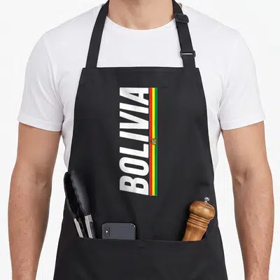 Souvenir bolivian apron - Vertical white BOLIVIA text beside a red yellow green flag strip with emblem — shown on a black cotton canvas apron against a white background