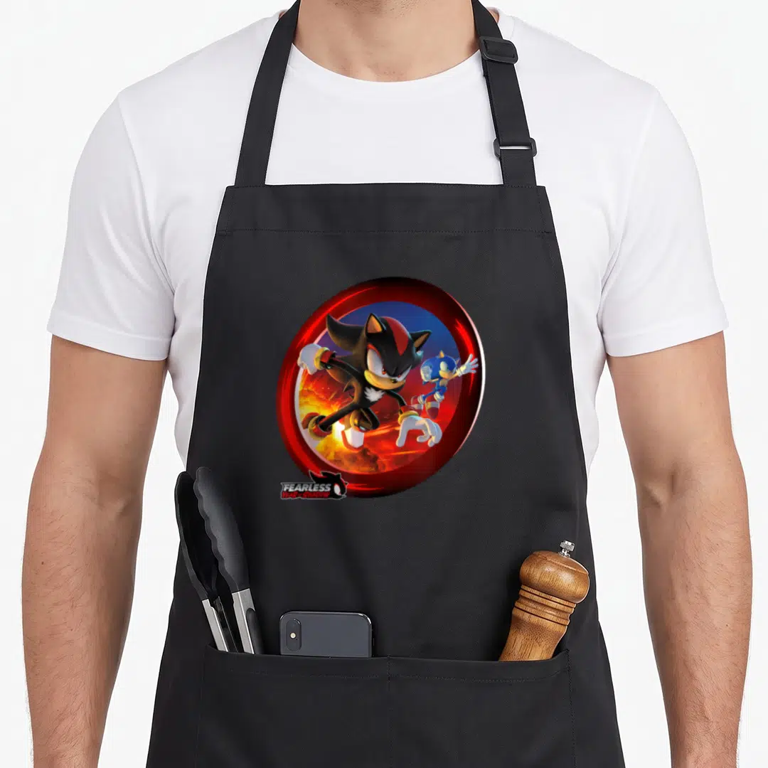 Fearless crazy hedgehog apron - Shadow and Sonic in red circle with fire, text FEARLESS YEAR OF SHADOW below — shown on a black cotton canvas apron against a white background