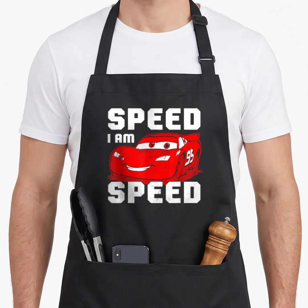 Funny speed car apron - Red cartoon race car with white SPEED text above and below — shown on a black cotton canvas apron against a white background
