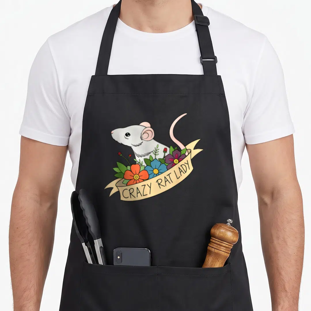 Flower pet apron - Cartoon rat behind orange blue purple flowers with CRAZY RAT LADY banner — shown on a black cotton canvas apron against a white background