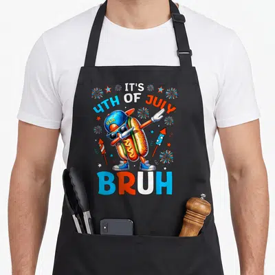 Hotdog 4th of july apron - Dabbing hot dog wearing USA cap and sunglasses with IT'S 4TH OF JULY USA BRUH text — shown on a black cotton canvas apron against a white background