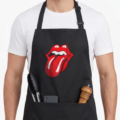 Baseball rolling stones apron - Distressed red open mouth with protruding tongue and white teeth outlined in black — shown on a black cotton canvas apron against a white background