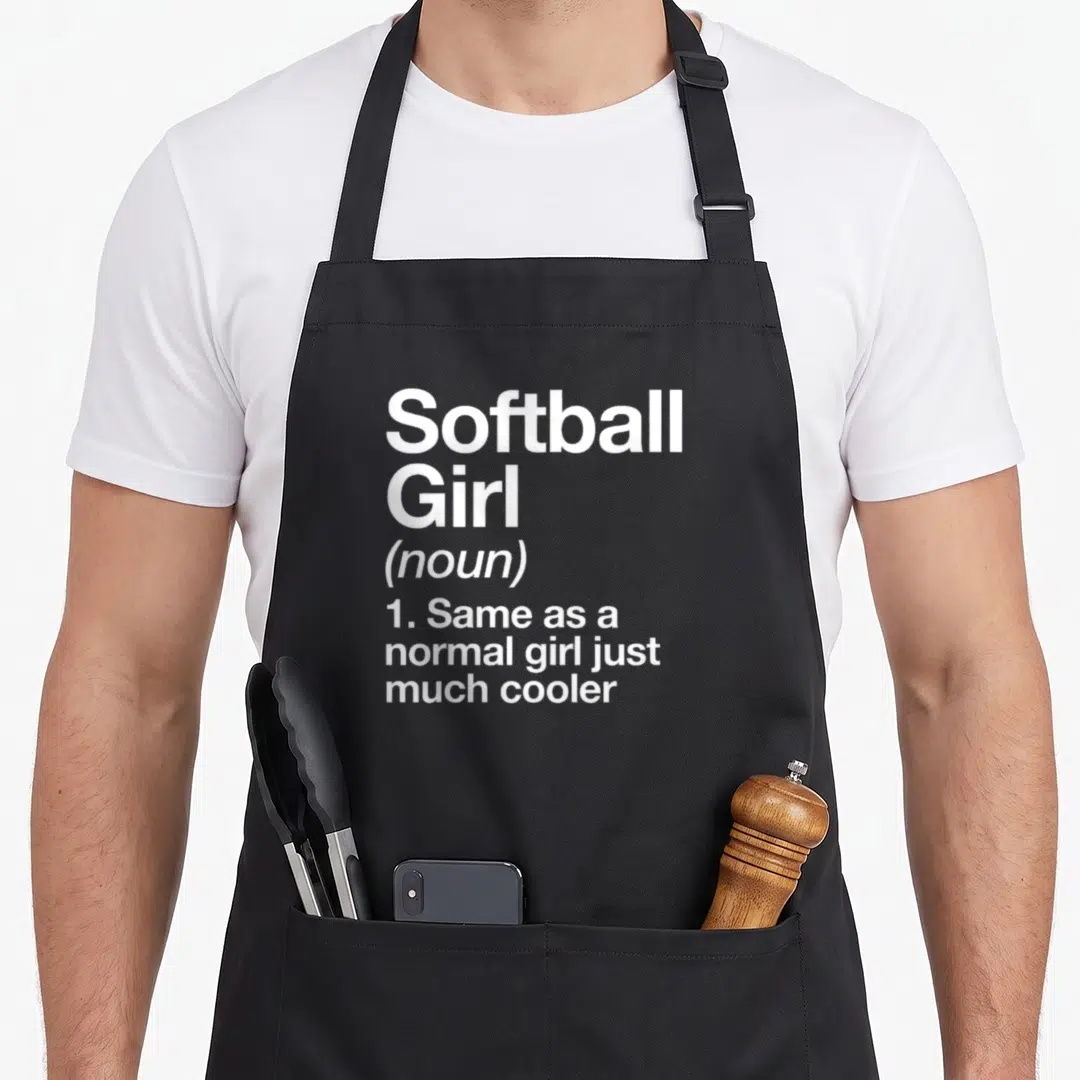 Softball sassy apron - White text reading Softball Girl noun same as normal girl just much cooler — shown on a black cotton canvas apron against a white background