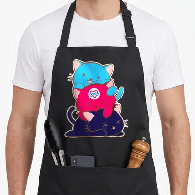 Alt cat apron - Three stacked cartoon cats in blue pink and dark blue with infinity heart on middle cat — shown on a black cotton canvas apron against a white background