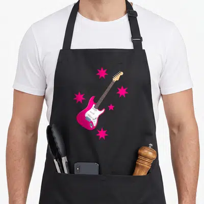 Electric rock concert apron - Pink electric guitar with white pickguard and four pink stars in cartoon style — shown on a black cotton canvas apron against a white background