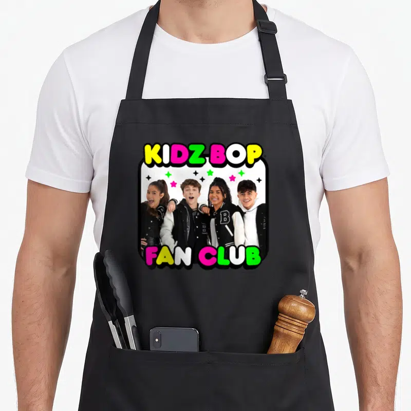 Bop fan club apron - KIDZ BOP FAN CLUB text around photo of four teens with colorful stars — shown on a black cotton canvas apron against a white background