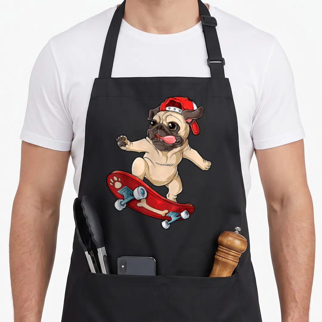 Skateboard dog apron - Cartoon tan pug standing on red skateboard with red cap and white wheels — shown on a black cotton canvas apron against a white background
