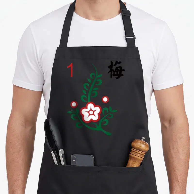 Chinese mahjong apron - Minimalist green stem white flower red number 1 and black kanji character — shown on a black cotton canvas apron against a white background