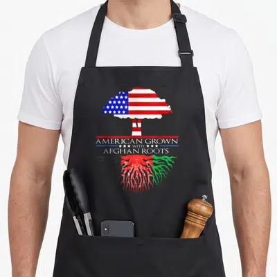 Grown asian apron - Tree with US flag canopy and Afghan flag roots text American Grown With Afghan Roots — shown on a black cotton canvas apron against a white background