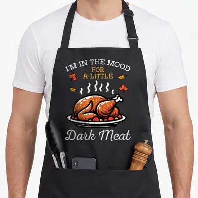 Mood thanksgiving day aprons - Cartoon roasted turkey with steam lines and autumn leaves surrounding text I'M — shown on a black cotton canvas apron against a white background