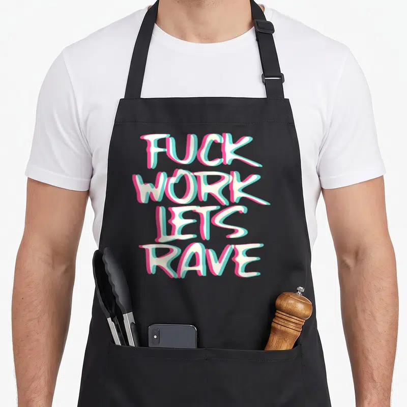 Glitch edm apron - Stacked typography reading FUCK WORK LETS RAVE in cream with pink and cyan 3D offset shadows — shown on a black cotton canvas apron against a white background