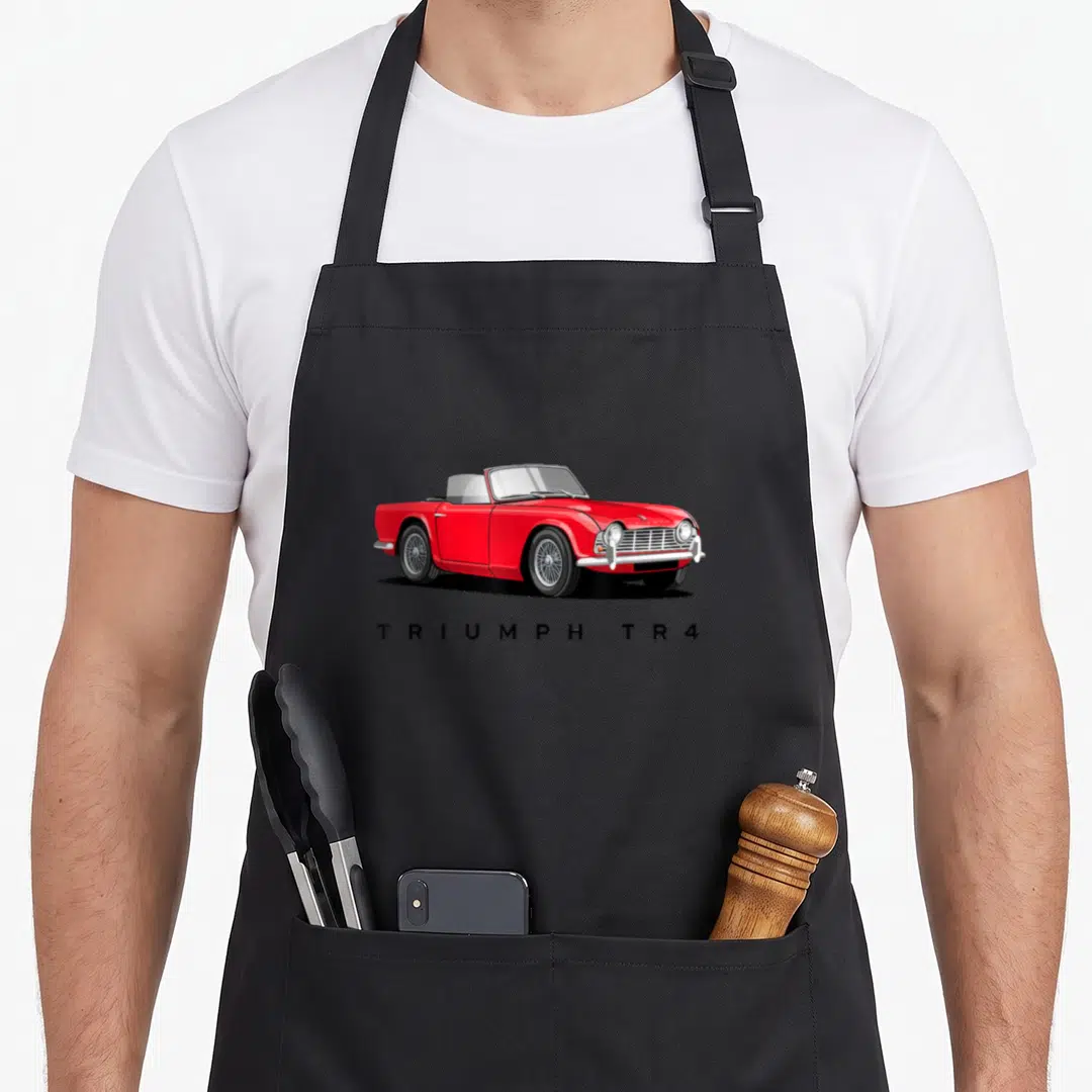 Retro sport car apron - Red Triumph TR4 convertible with spaced black text below — shown on a black cotton canvas apron against a white background