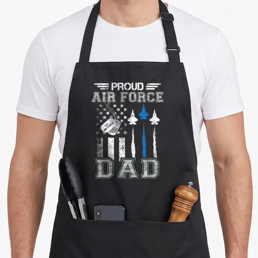 Graduation us aprons - PROUD AIR FORCE U.S. AIR FORCE DAD with jets dog tags distressed print — shown on a black cotton canvas apron against a white background