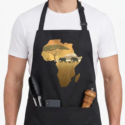 Map animal apron - African continent silhouette containing elephants, giraffes, acacia tree, and mountain in tan — shown on a black cotton canvas apron against a white background
