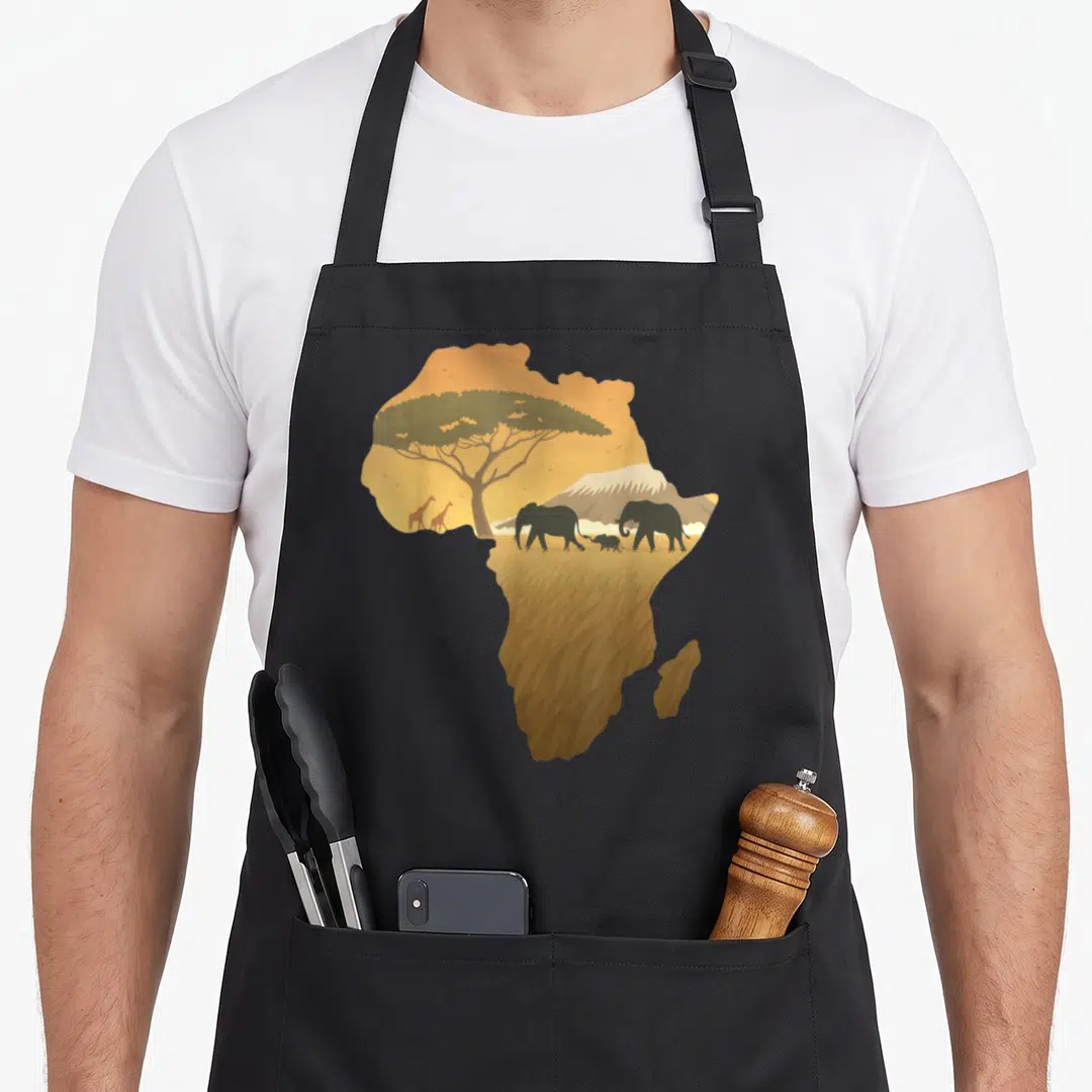 Map animal apron - African continent silhouette containing elephants, giraffes, acacia tree, and mountain in tan — shown on a black cotton canvas apron against a white background